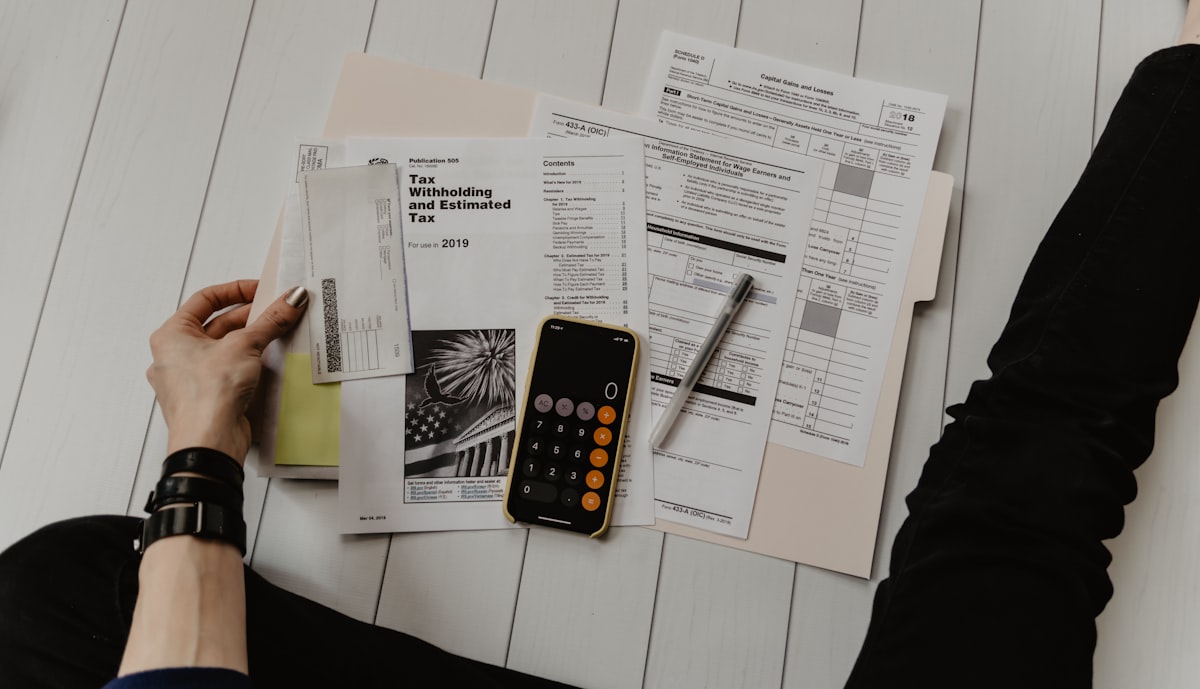 Calculator and financial spreadsheet on desk