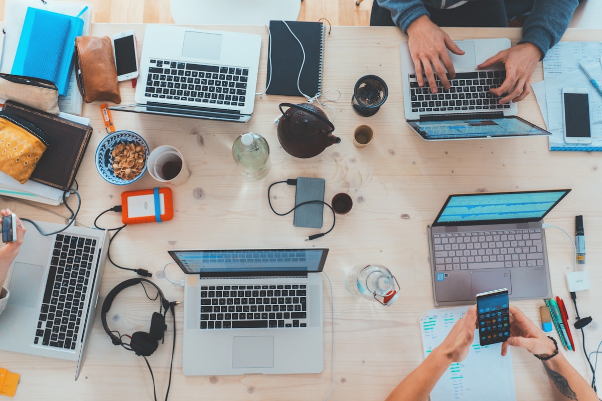 Team working together with multiple devices